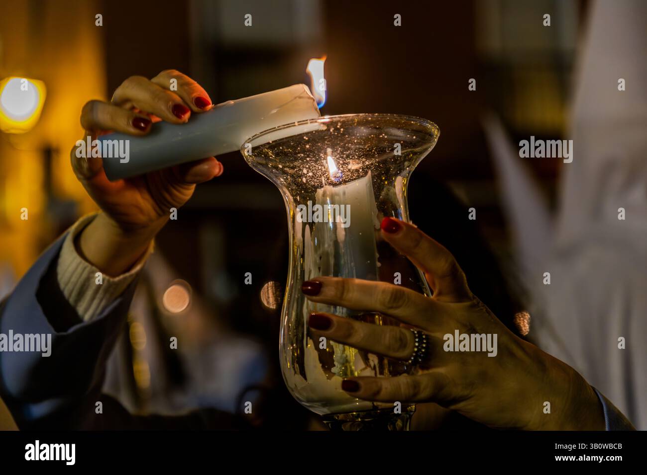 A person lights a candle in Spain. Bajada San Miguel, Cuenca, Castilla-La Mancha, Spain Stock Photo