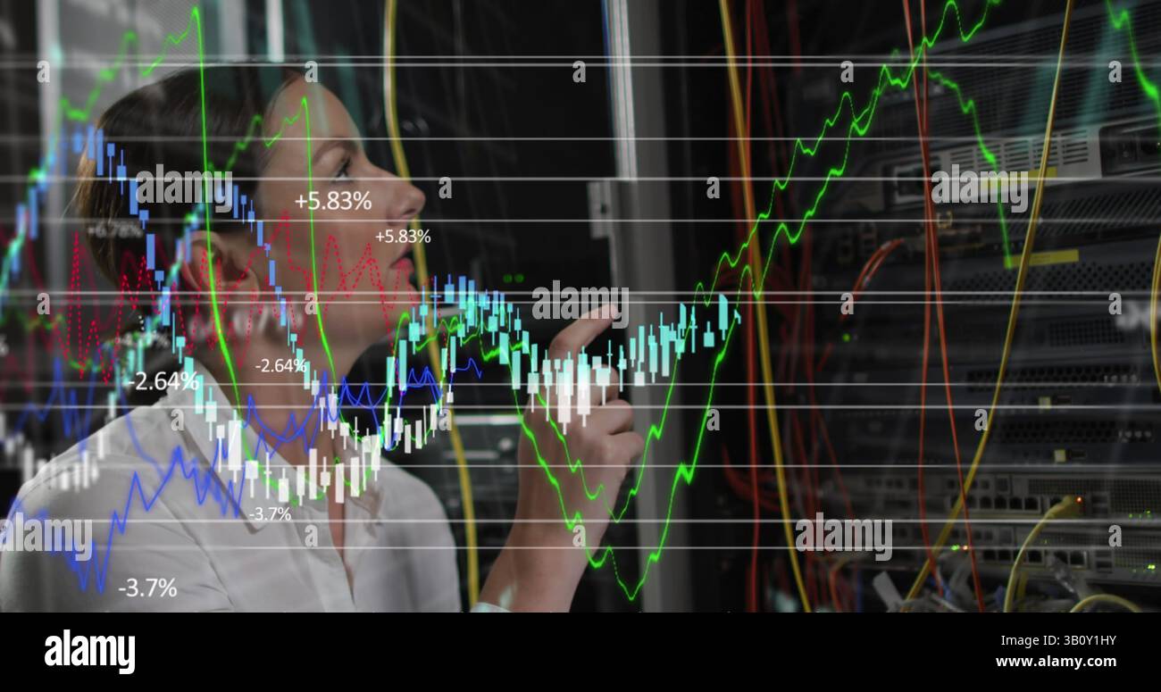Financial data processing over thoughtful caucasian female engineer working in computer server room Stock Photo