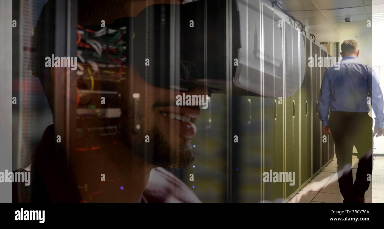 Image of server room over biracial man using vr headset Stock Photo