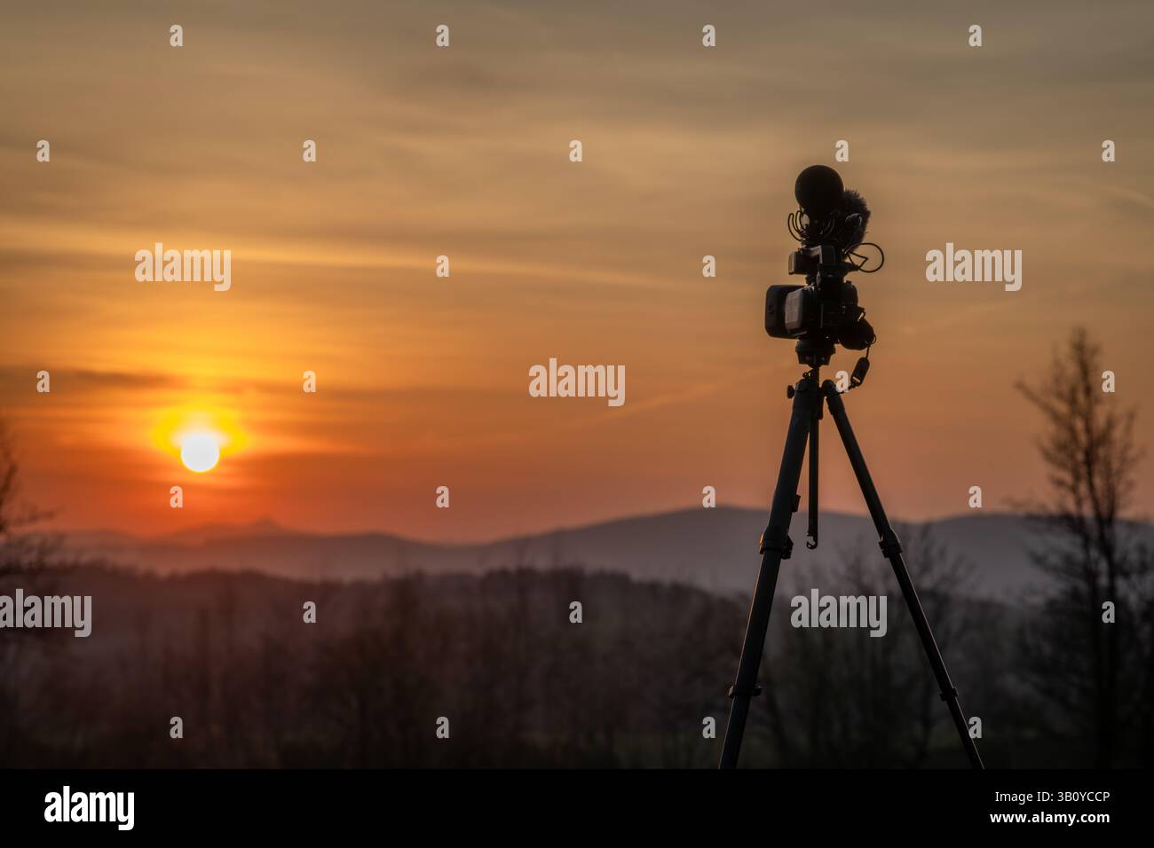 Camera and microphones on tripod in mountains with sunset near Vysoke ...
