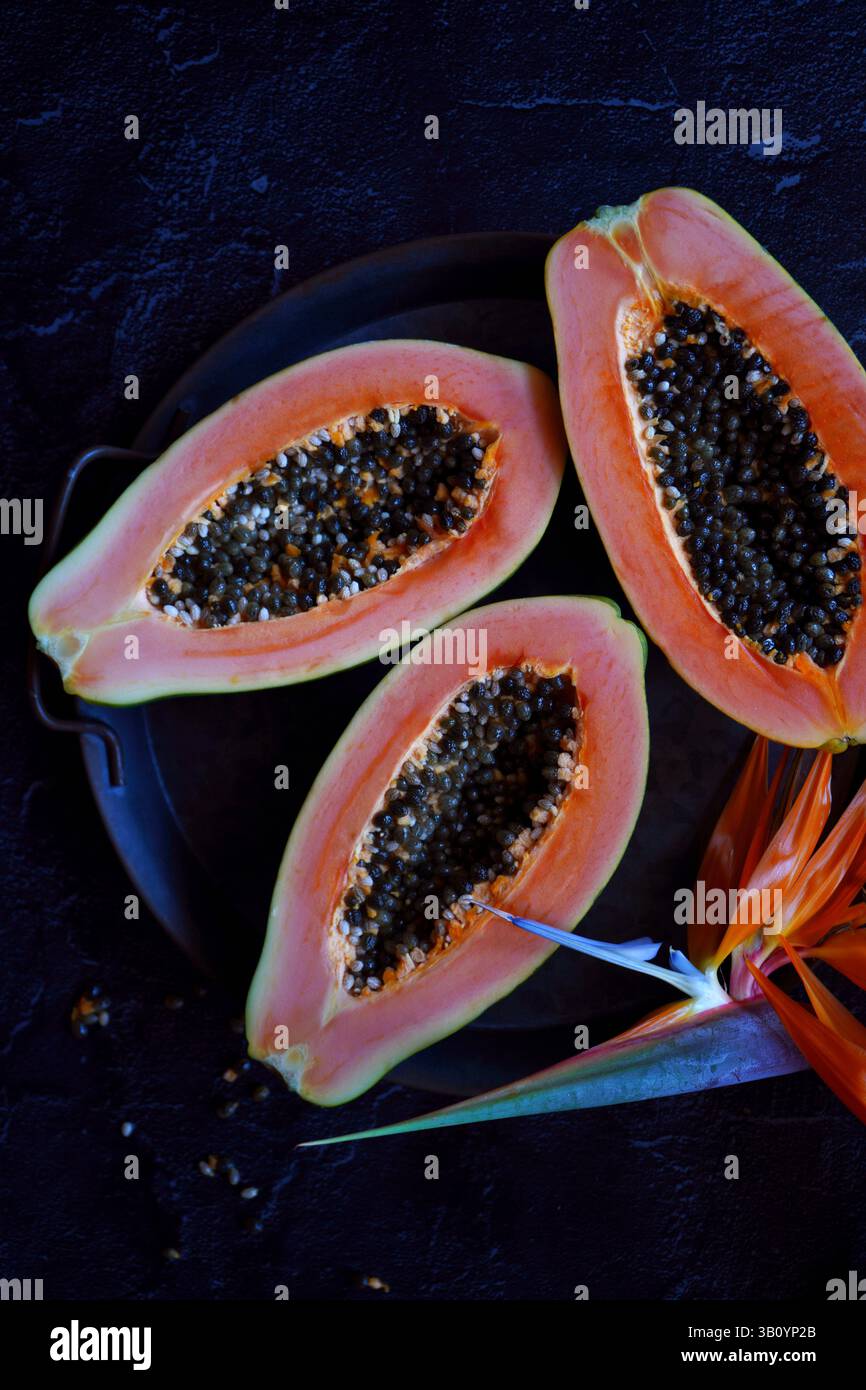 Ripe tropical papaya fruit on black background. Stock Photo