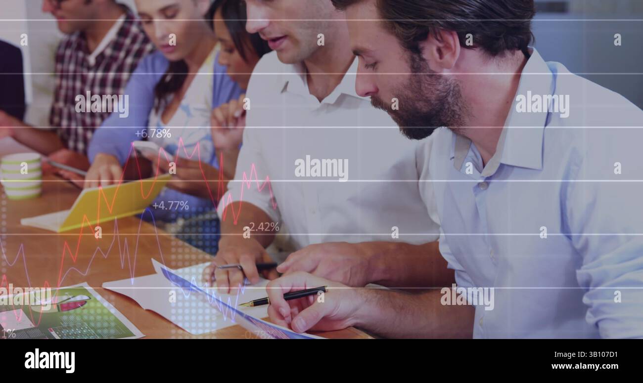 Statistical data processing against two caucasian men discussing at office Stock Photo