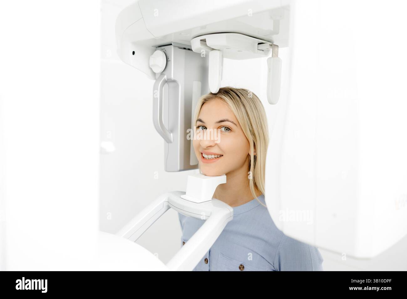 Patient receiving a dental panoramic radiography exam in a state-of-the ...
