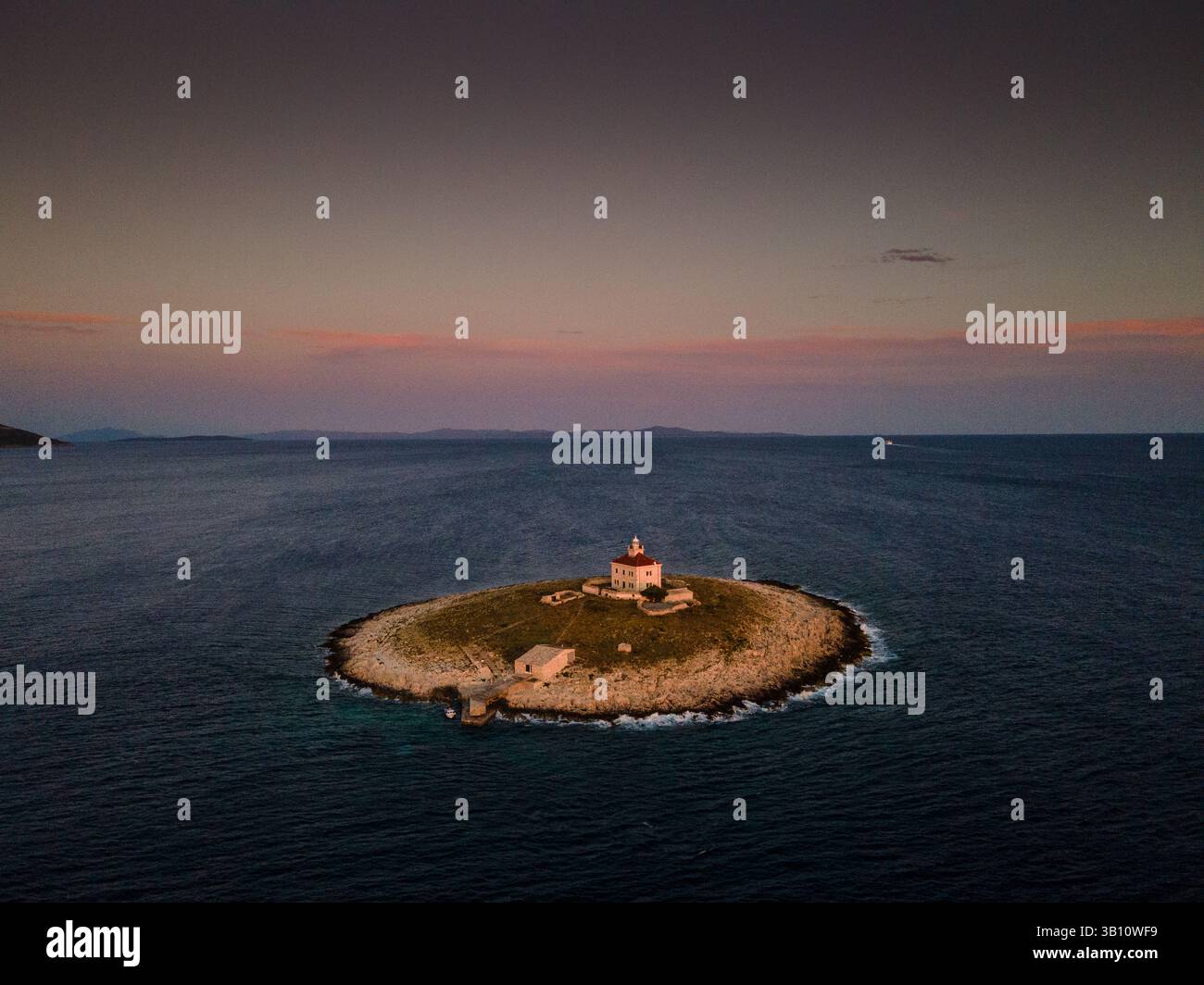 The Pokonji Dol Lighthouse on Otocic Pokonji Dol Island off the coast of Hvar Island, Croatia. Stock Photo