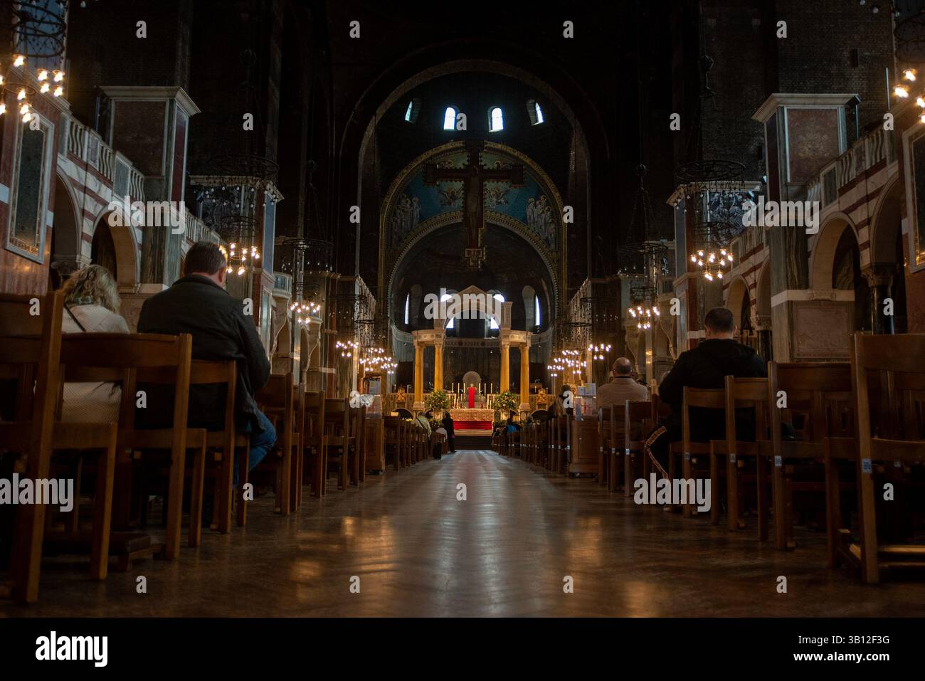 London, UK. 24th Apr, 2025. Mourners sit at the benches before the service for Pope Francis at the Westminster Cathedral. The head of the Catholic Church, Pope Francis died on Easter Monday on 21st of April 2025 at the age of 88 in Vatican. Since Monday thousands of believers are going daily to the Westminster Cathedral in London to pay respect to him. Credit: SOPA Images Limited/Alamy Live News Stock Photo