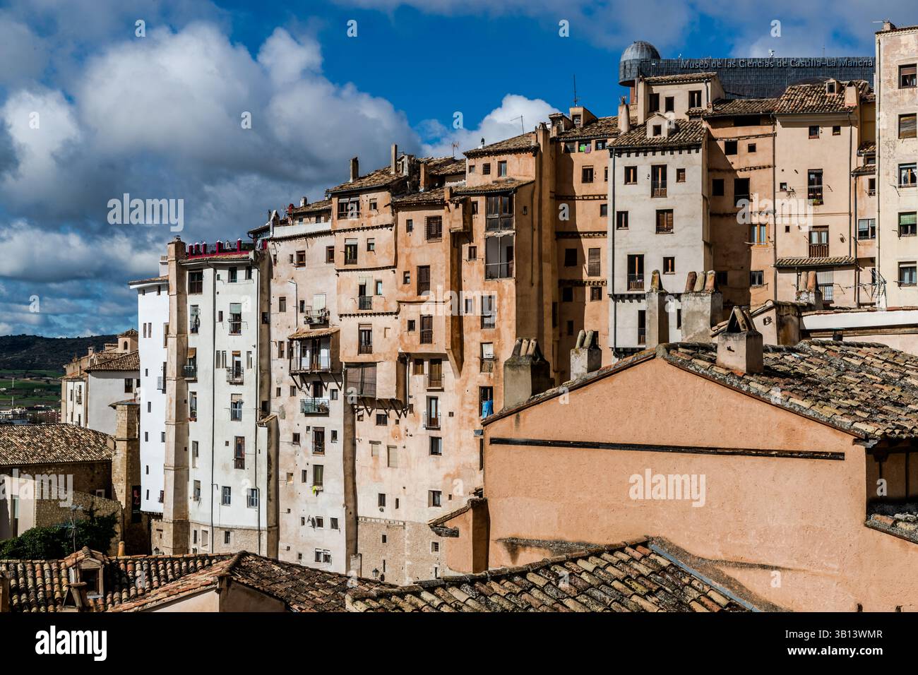 In Cuenca, high-rise buildings were erected on a rugged rocky plateau between the gorges of the Júcar and Huécar rivers as early as the Middle Ages. The roofed balcony marks the height of the street where the entrance to the house is located. Calle Canónigos, Cuenca, Castilla-La Mancha, Spain Stock Photo