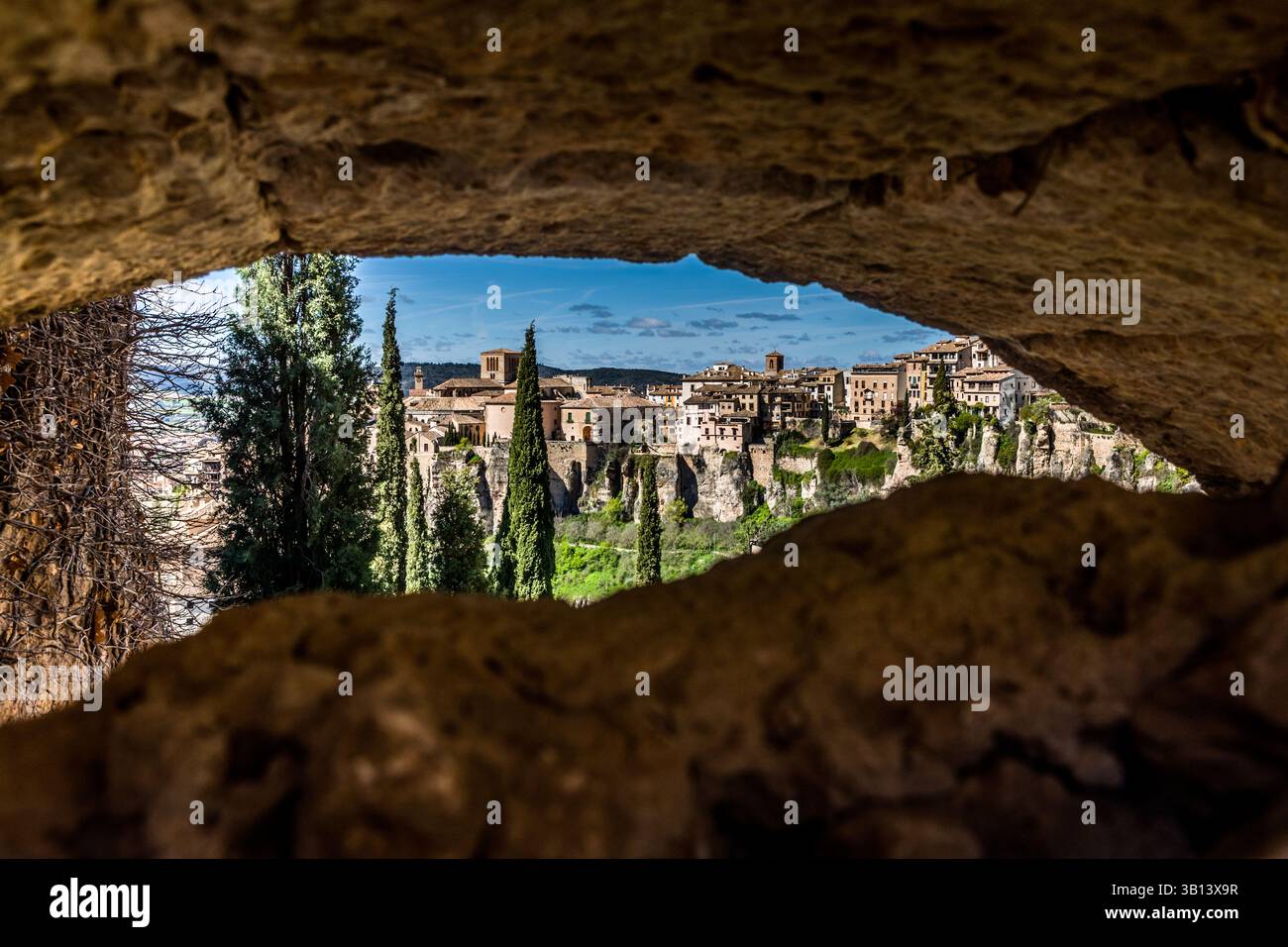 View of the Spanish city of Cuenca through a rocky niche. Calle Larga, Cuenca, Castilla-La Mancha, Spain Stock Photo