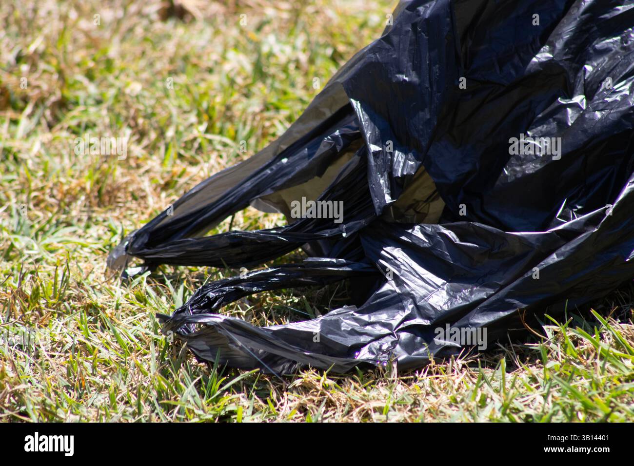 black trash bag in public park Stock Photo