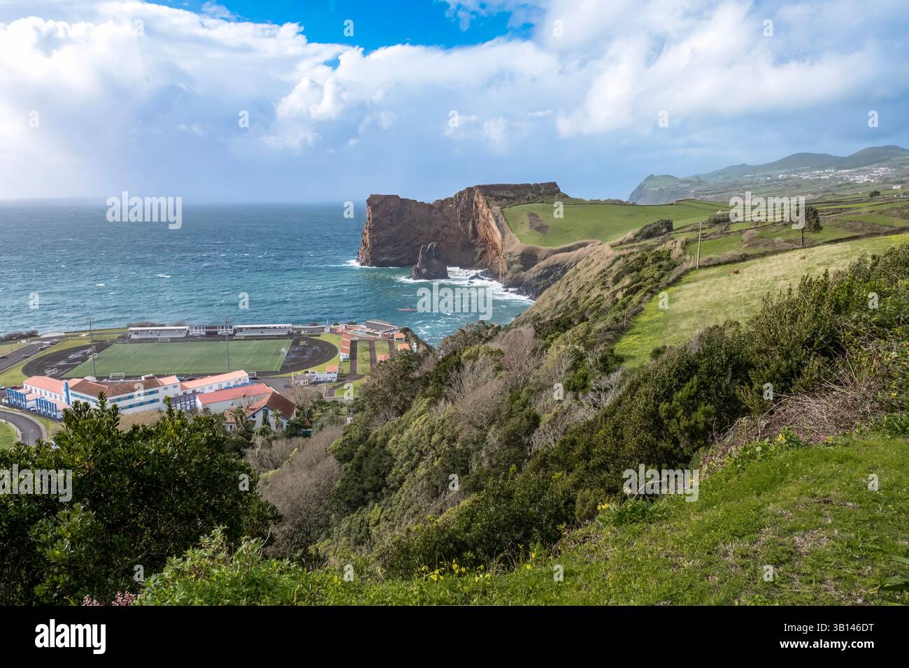 Dramatic casting over the rugged volcanic coastline and turbulent ocean of Sao Jorge Island in the Azores, Portugal. This scenic view captures the tra Stock Photo