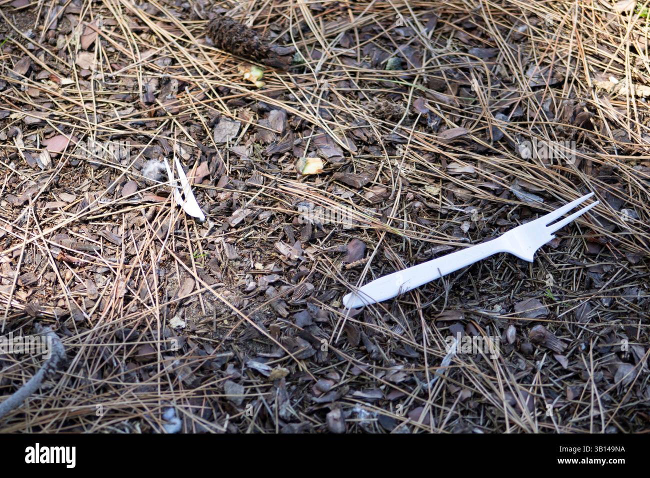 white plastic utensils on ground Stock Photo