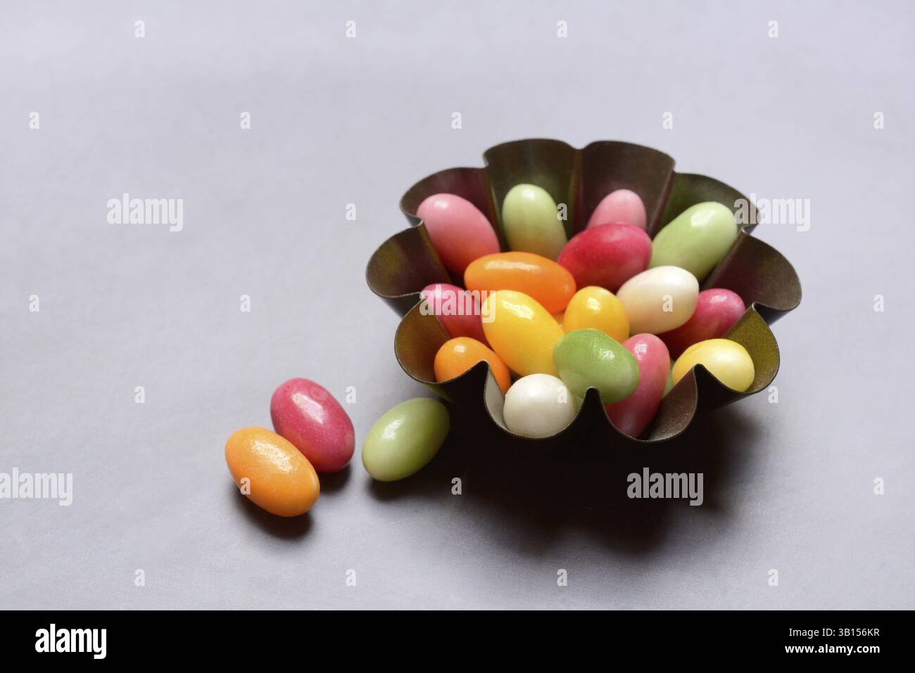 Colourful sugar eggs in baking tin, Easter Stock Photo