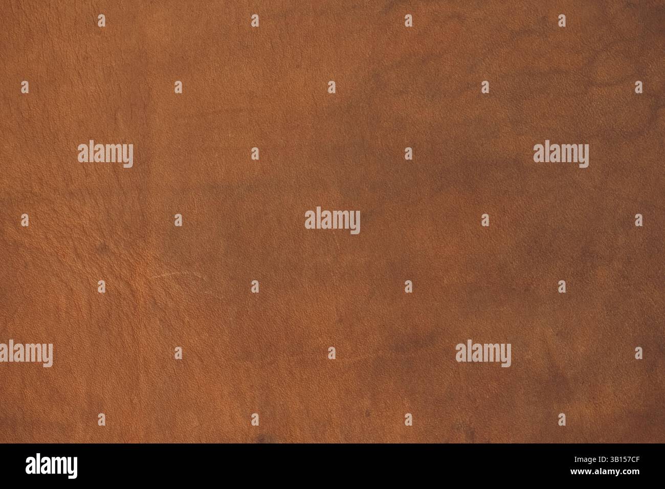 Genuine light brown leather texture. Calfskin leather surface with natural unique pattern, background, close-up, high resolution. Stock Photo