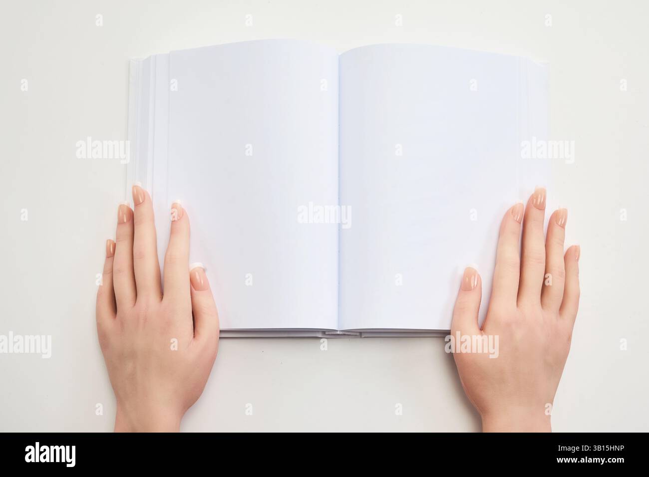 Open Blank Notebook. Hands holding an open blank notebook Stock Photo