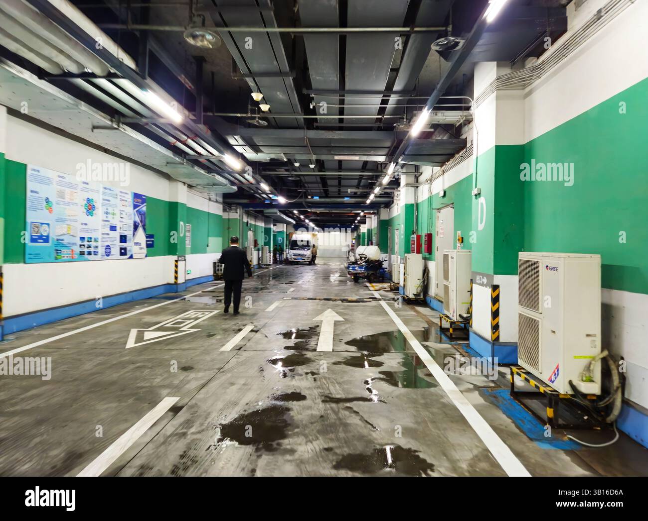 Underground Service Corridor of Commercial Building with Maintenance Equipment and Logistics Operations Stock Photo