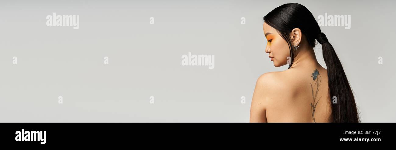 Young Asian woman poses gracefully, showcasing her styled hair and ...