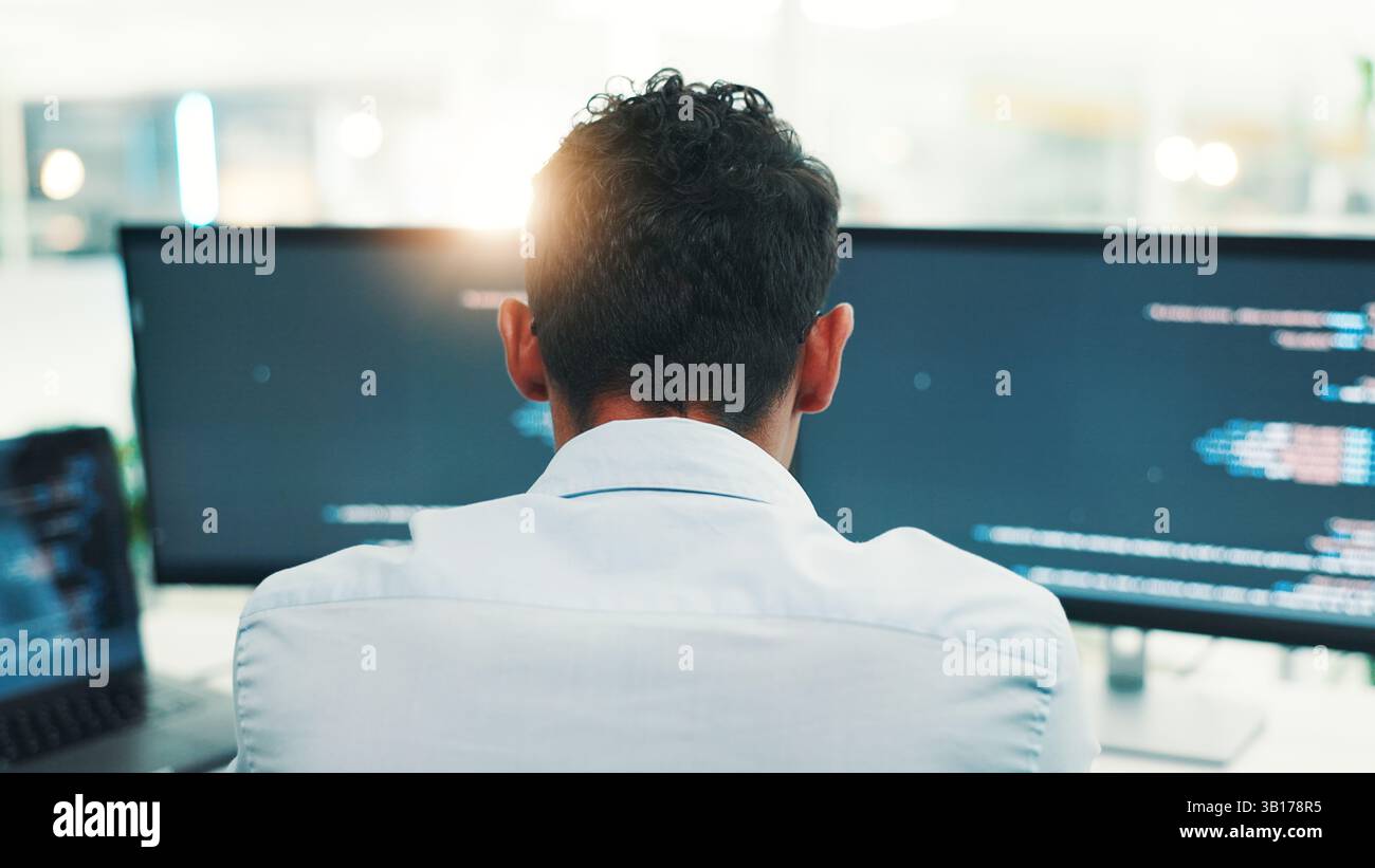 Programmer, man and computer screen with reading in office for writing code, planning digital software and debugging. Back, programming and employee Stock Photo