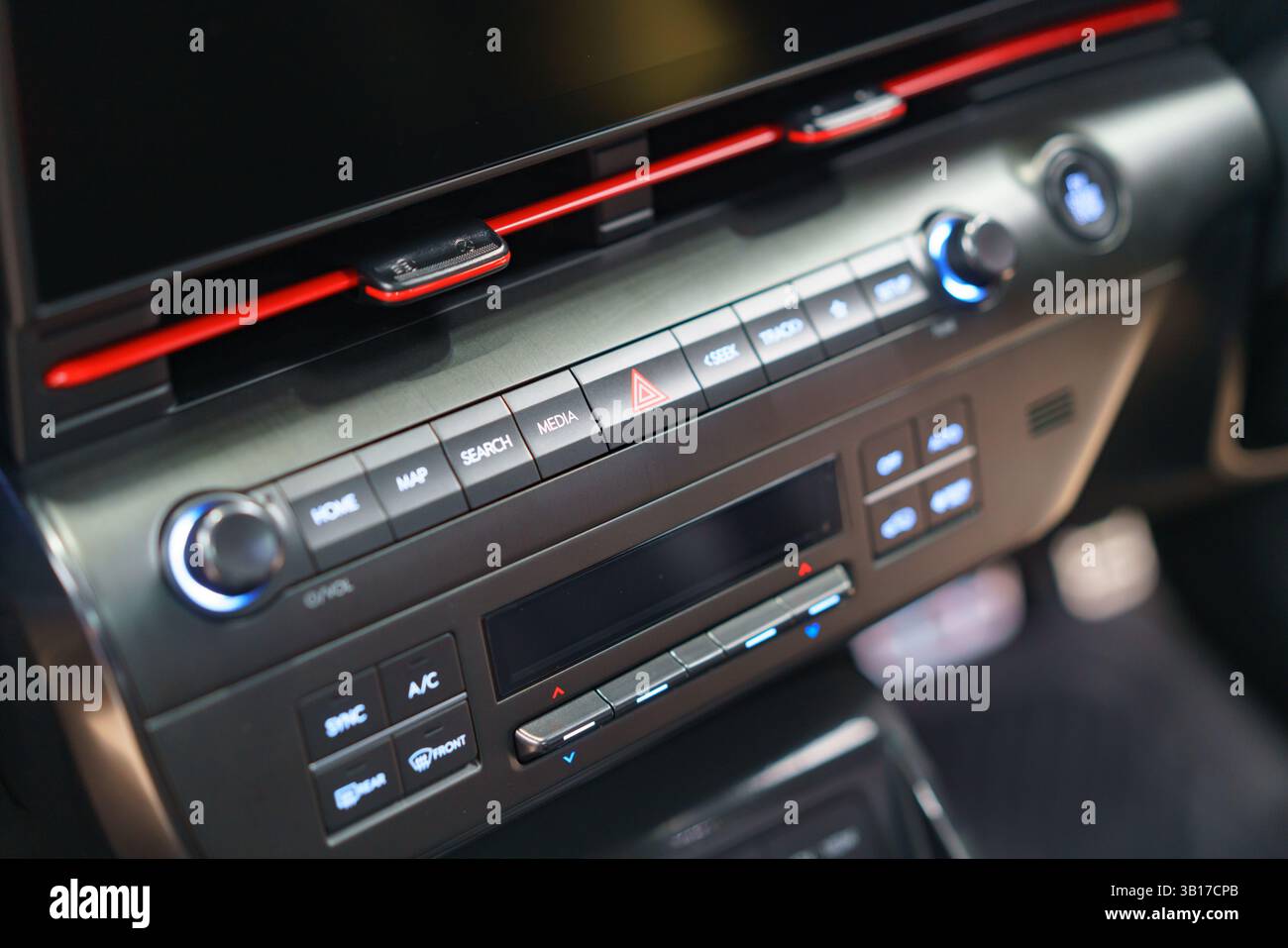 Modern dashboard featuring a hazard light, radio, and climate controls. Sleek design and user-friendly features for comfortable driving. Stock Photo