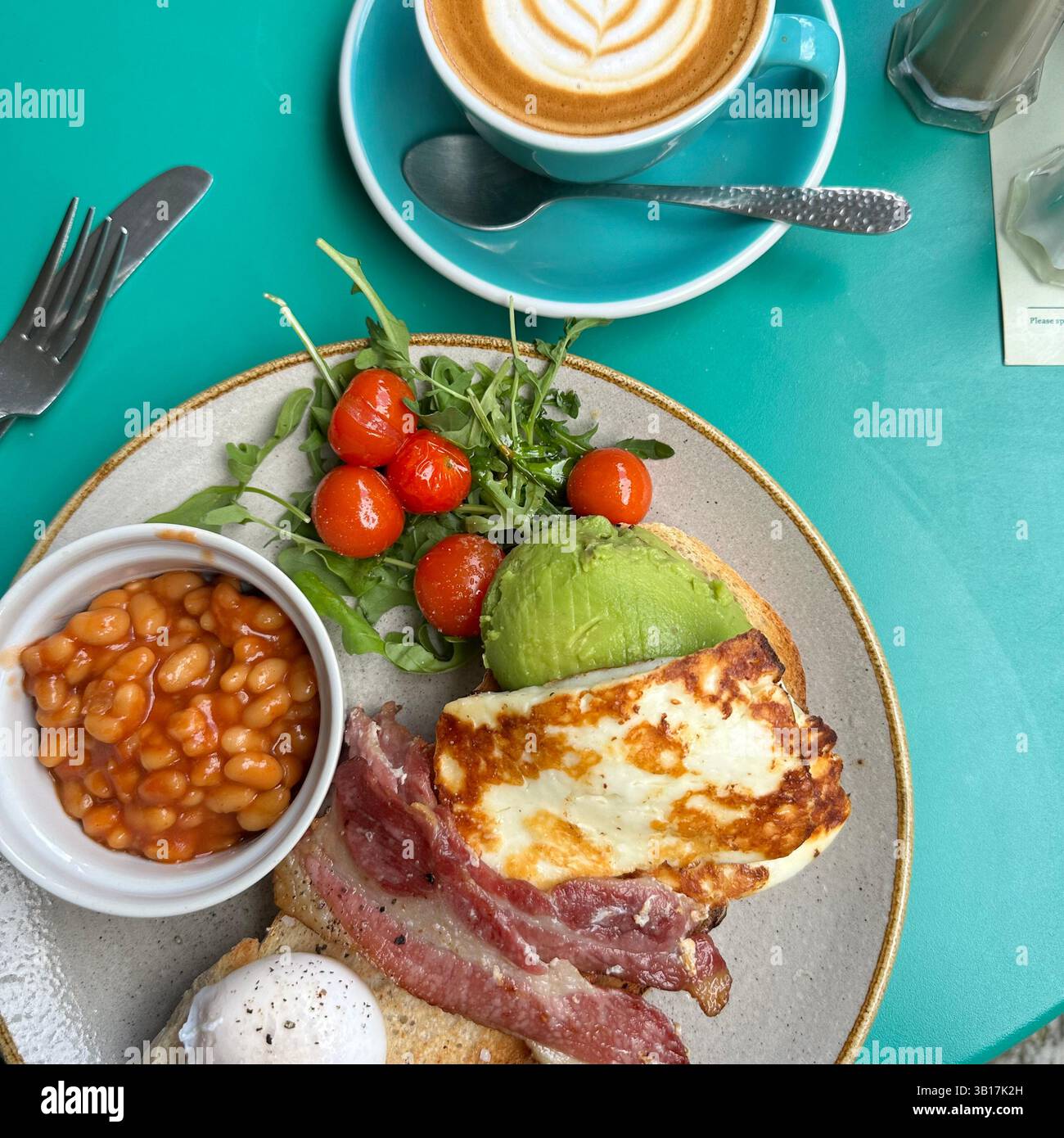 An overhead shot of a bright cheery breakfast table with a coffee and a modern English breakfast - Smartphone Captured Stock Image
