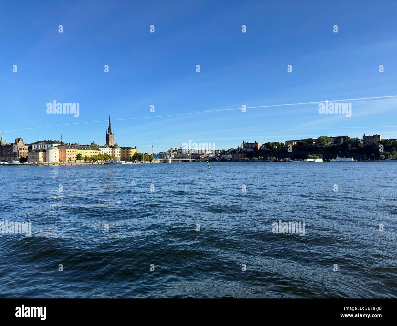 Beautiful view of Stockholm's cityscape on a sunny day with calm water and a clear sky. - Smartphone Captured Stock Image