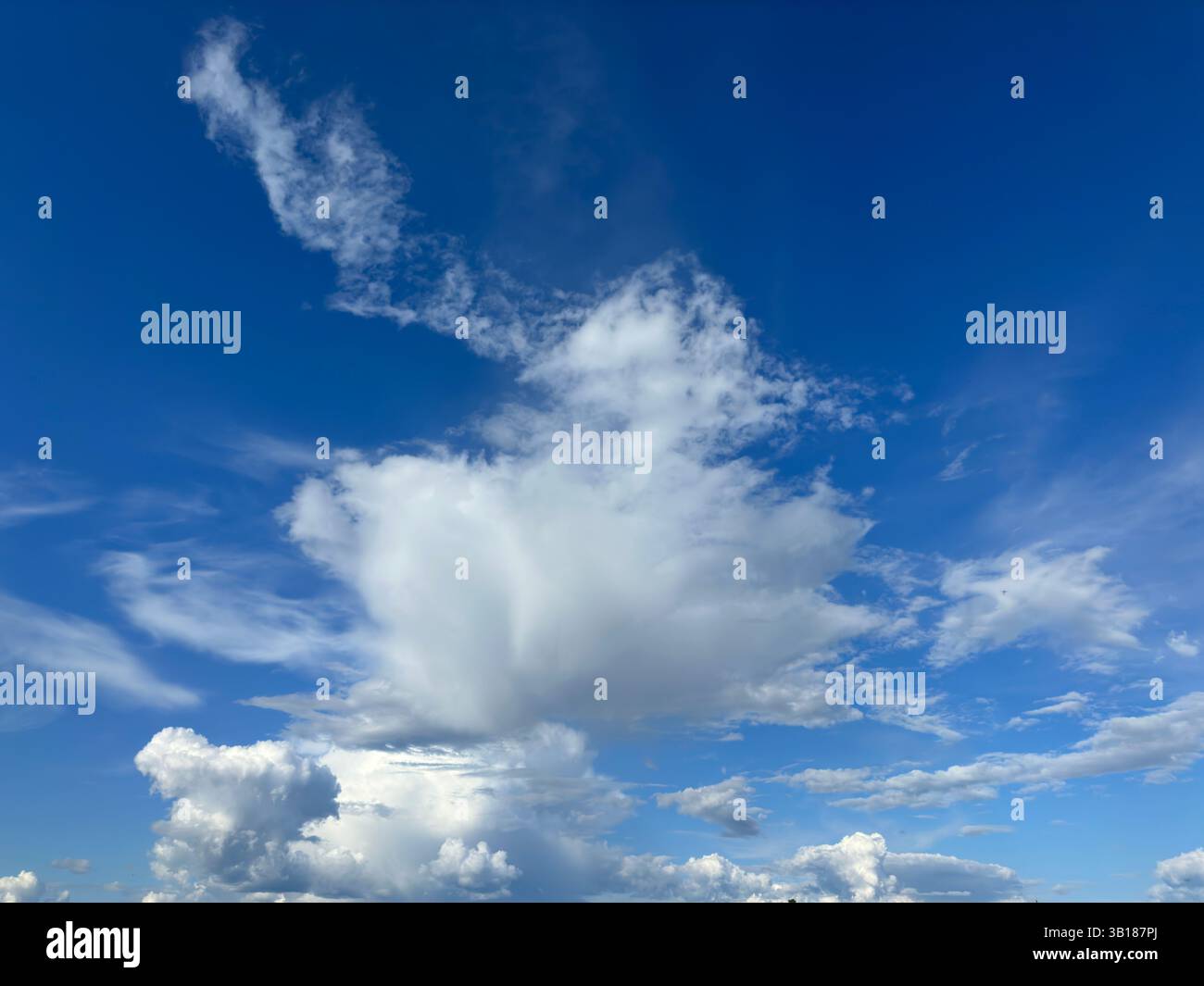 Vivid blue sky with various fluffy clouds creating a stunning and natural landscape. - Smartphone Captured Stock Image