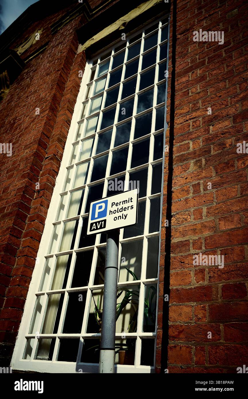 Parking permit holders only on sign in front of former chapel window ...