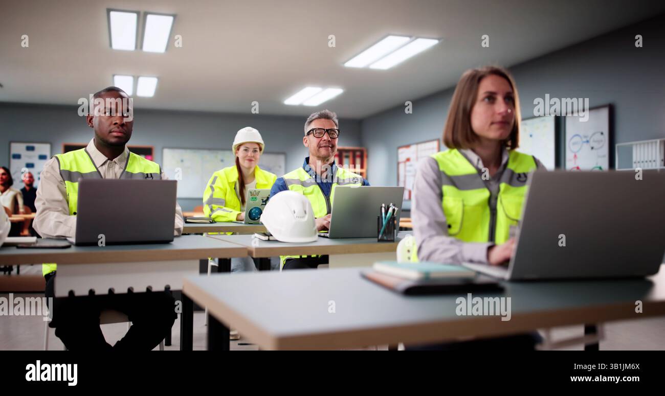 Students Work In A Classroom With Laptops, Learning Diverse Software. Stock Photo