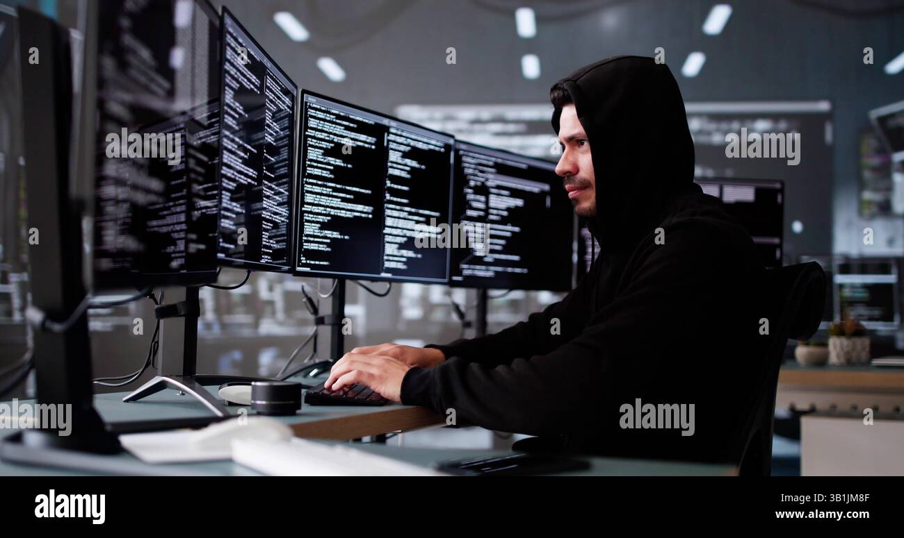 Hacker And Computer Data Breach. Cyber Risk Stock Photo