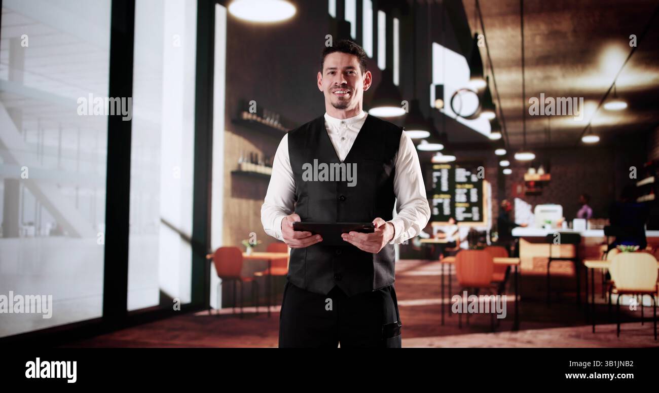 Success In The Cafe: Latino Owner Using Tablet To Plan. Stock Photo