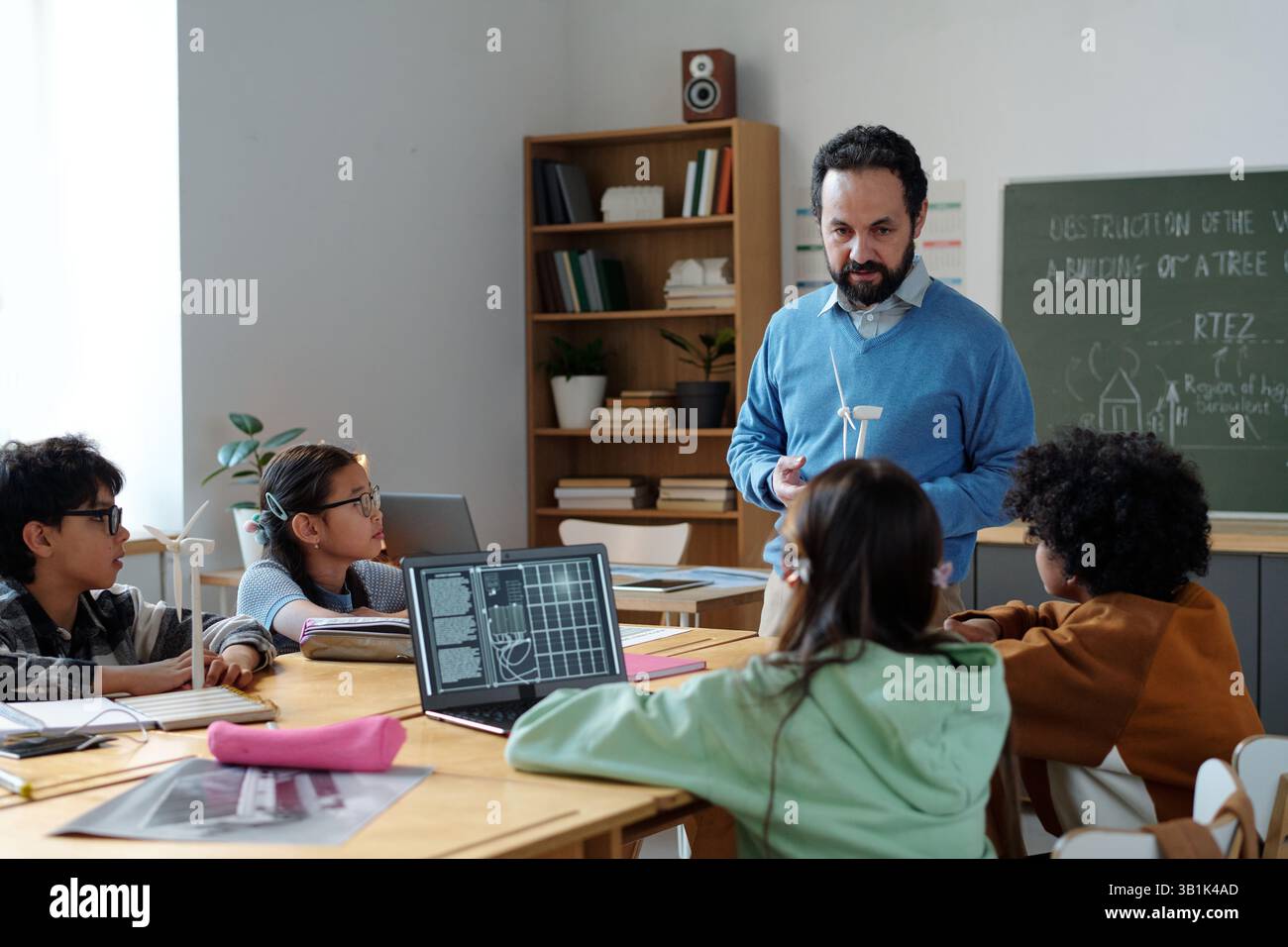Educator Engaging Students in Technology-Enhanced Classroom Stock Photo