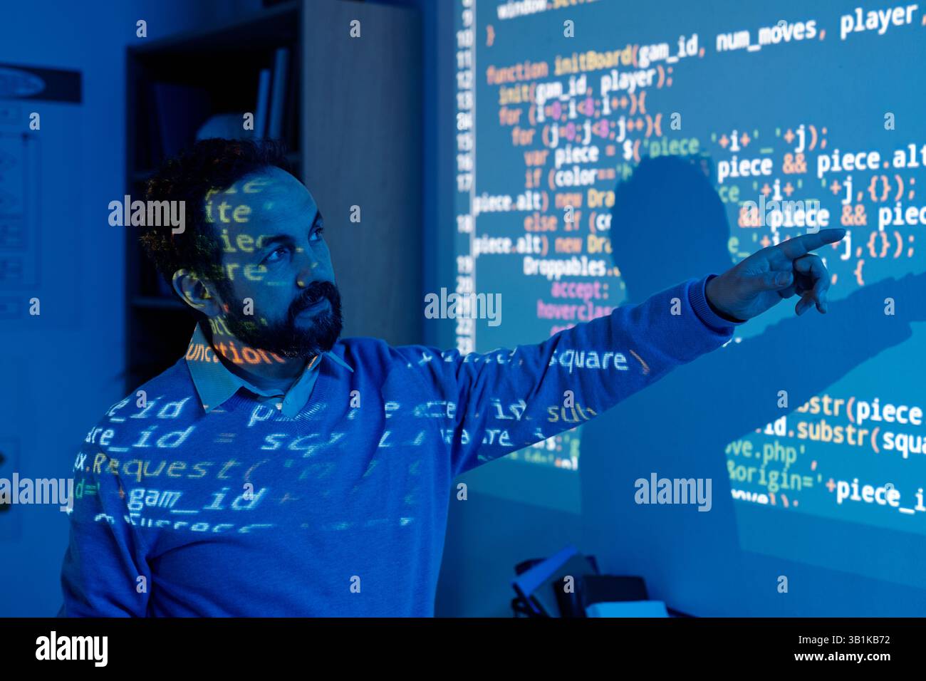 Software Developer Interacting with Projected Code Stock Photo