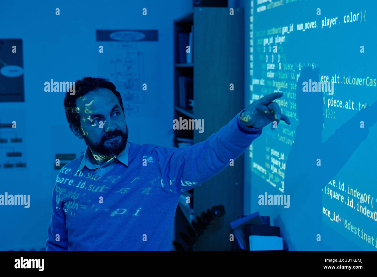Man Interacting with Projected Screen Display in Office Stock Photo