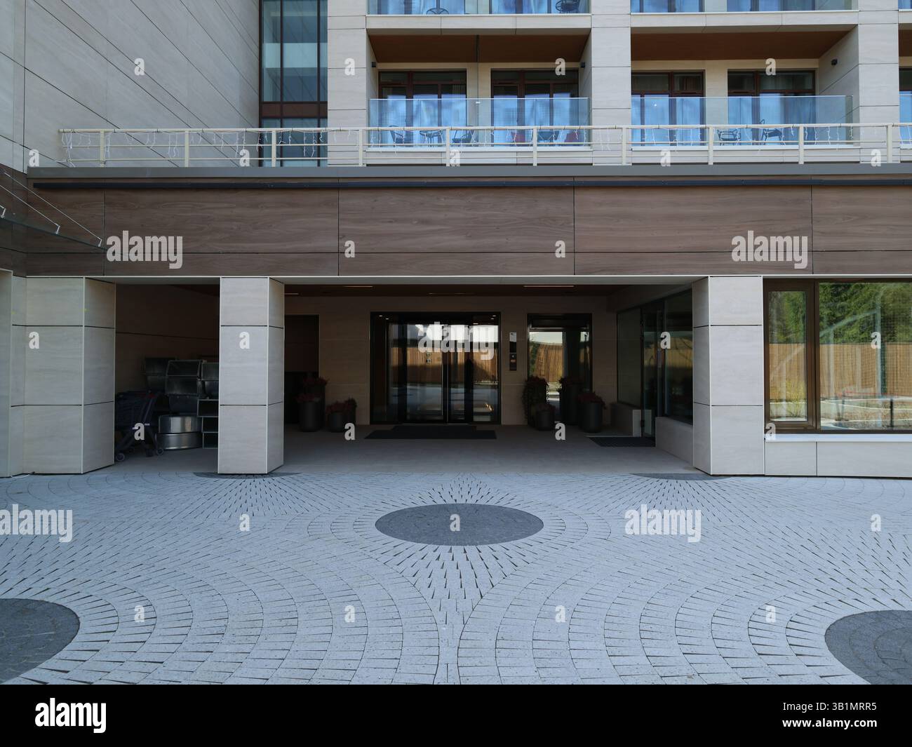 The entrance of a modern building features a beautifully designed ...