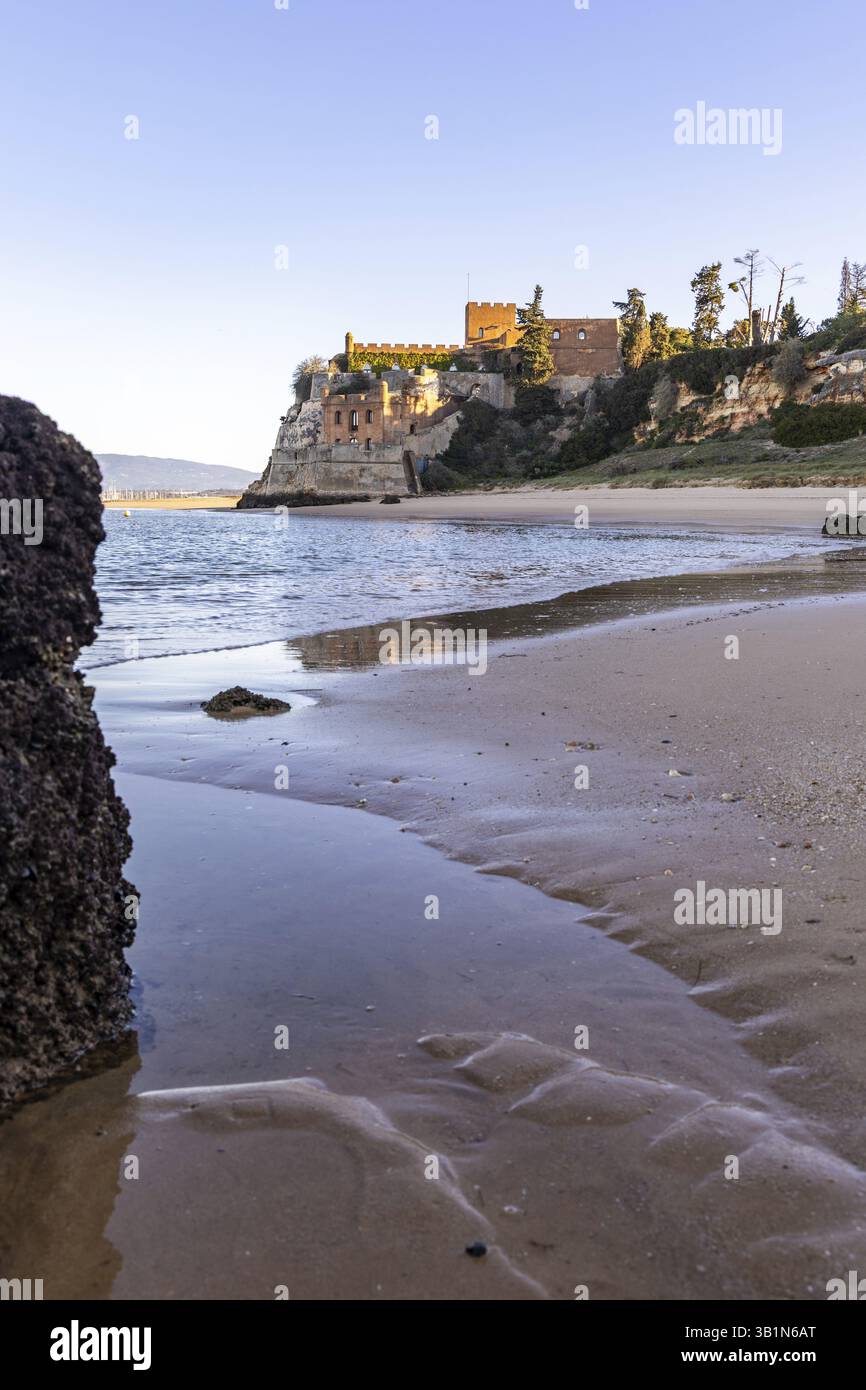 Sunrise on the Atlantic, a castle in the middle of the beach. A ...