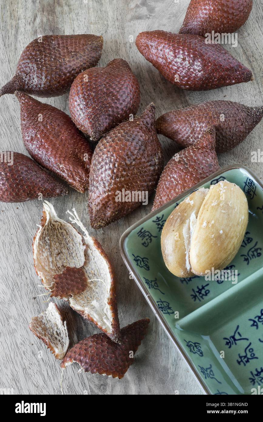 Snake fruit on a wooden board Stock Photo
