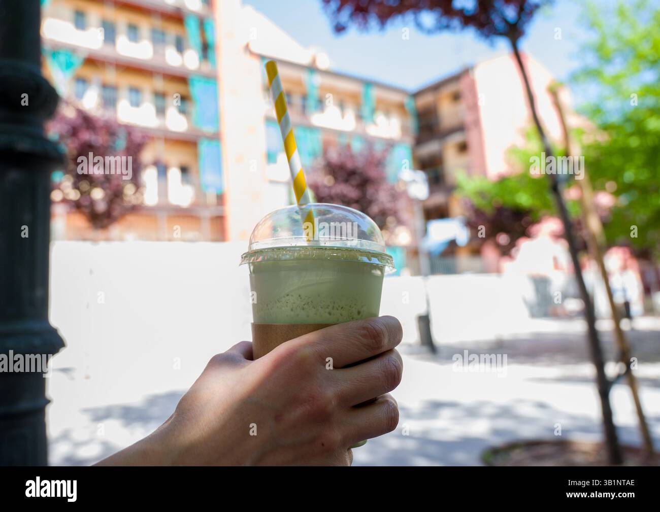 woman having iced matcha latte Stock Photo
