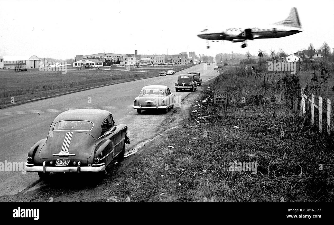 Feb. 24, 1952 - Memphis, TN, U.S. - Despite warning signs at Municipal Airport, these Sunday afternoon airplane watchers on Feb. 24, 1952 parked directly in the path of landing airliners on Winchester.  A sudden down-draft could mean death to those in the cars and the plane.  Three white lines across the road indicate the danger zone.  Several years ago, a man was killed when a landing plane struck a car in a similar danger zone on Airways. (Credit Image: © The Commercial Appeal/ZUMApress.com) Stock Photo