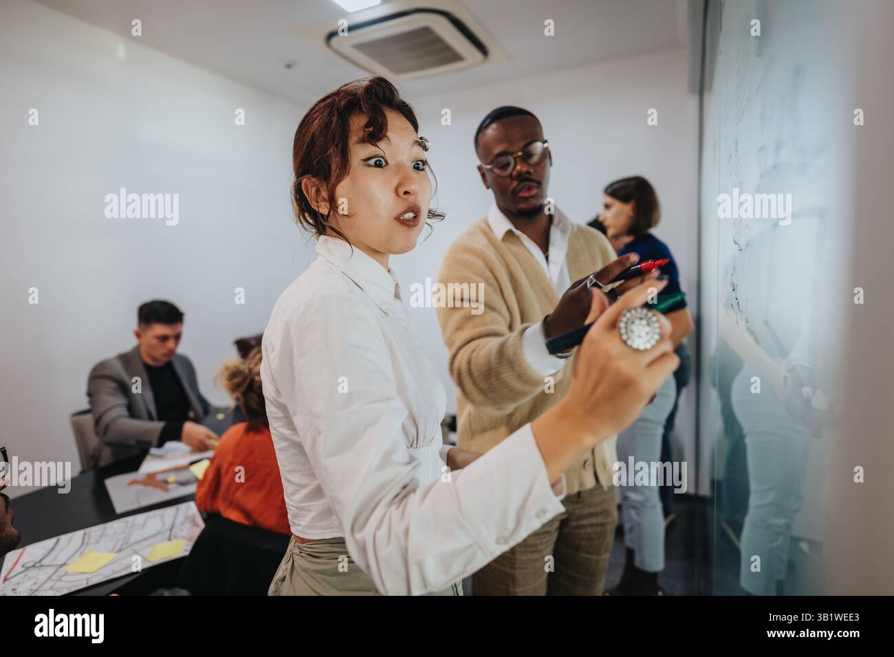 Multicultural team brainstorming and discussing project in modern office Stock Photo