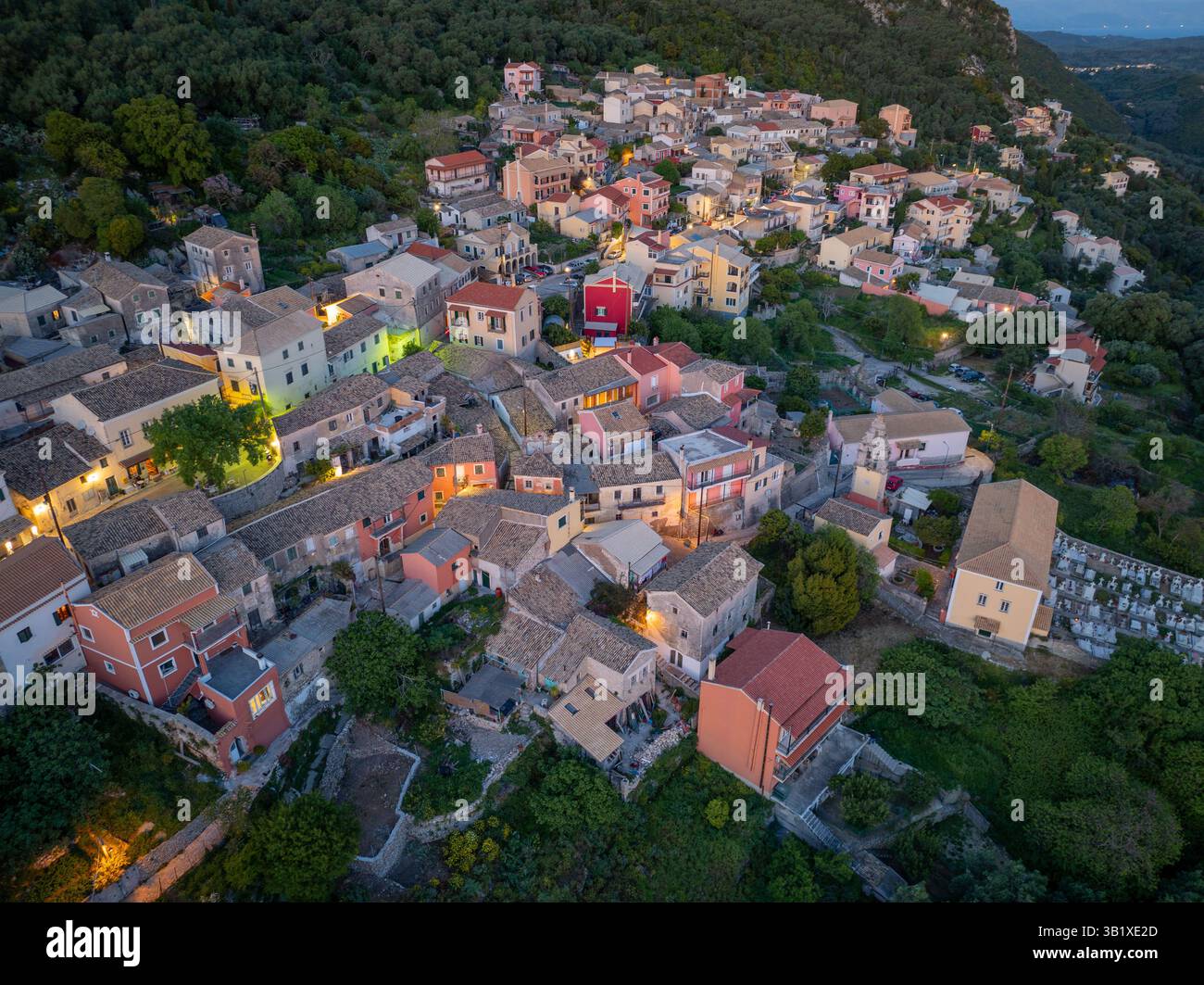 Aerial view showcases a charming village nestled amidst lush greenery ...