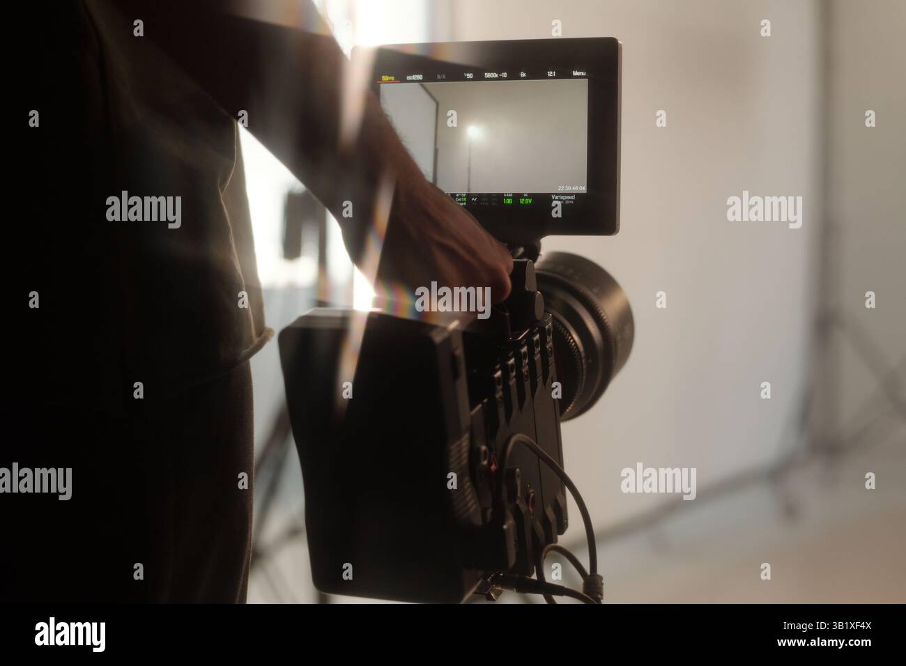 Production Crew Holding Camera during Video Shoot Stock Photo