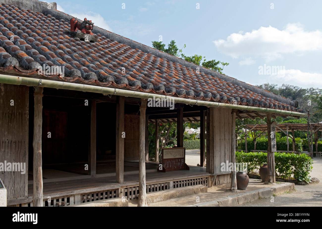 Traditional Okinawan historical residence with ceramic roof tiles and broad overhangs at the Ryukyu open air museum in Okinawa, Japan. Stock Photo