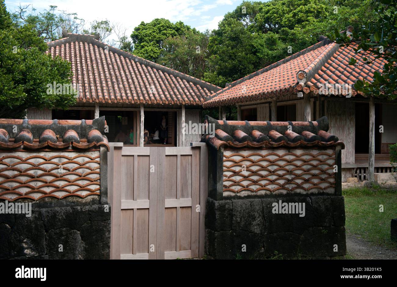Okinawan residence wall has a wave-like pattern created with used roof tiles seen at the Native Okinawan Village in Ocean Expo Park, Okinawa, Japan. Stock Photo