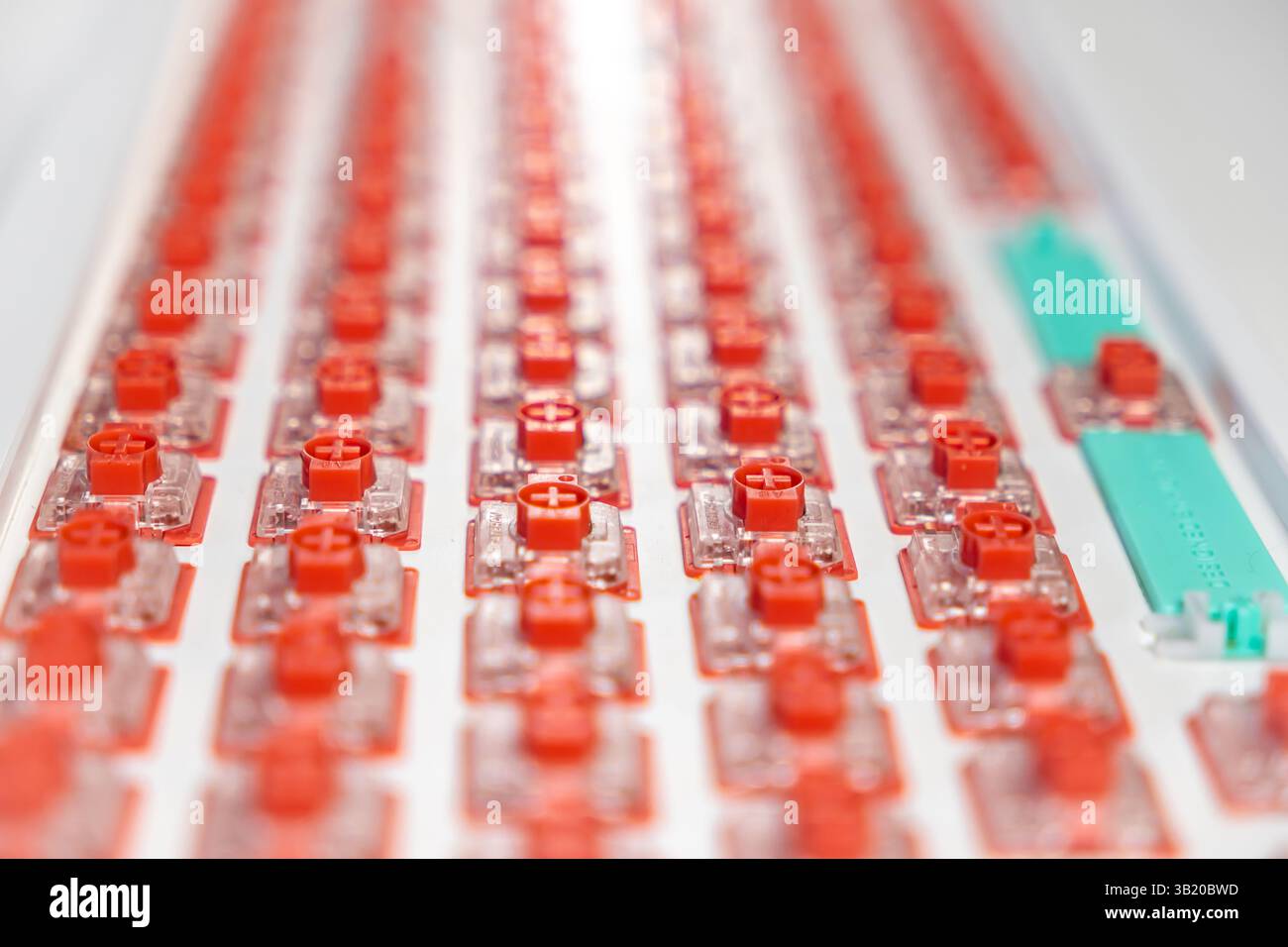 Close-up perspective of red mechanical switches precisely installed in ...