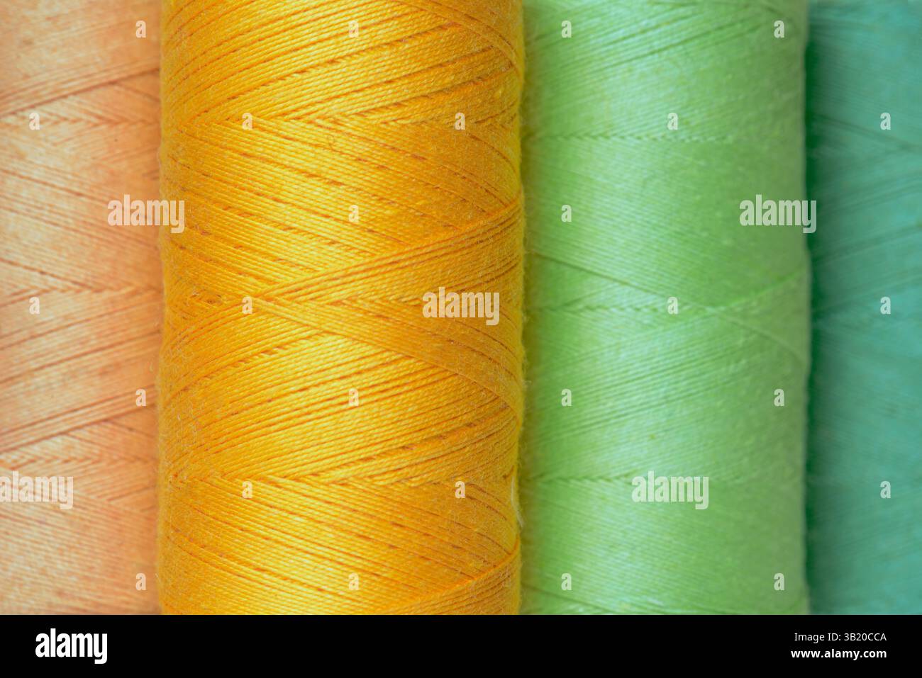 Multicolor reels of sewing threads full background Stock Photo