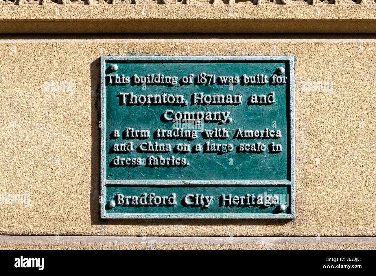 A green plaque on Thornton, Homan & Company building in Little Germany, Bradford. Stock Photo