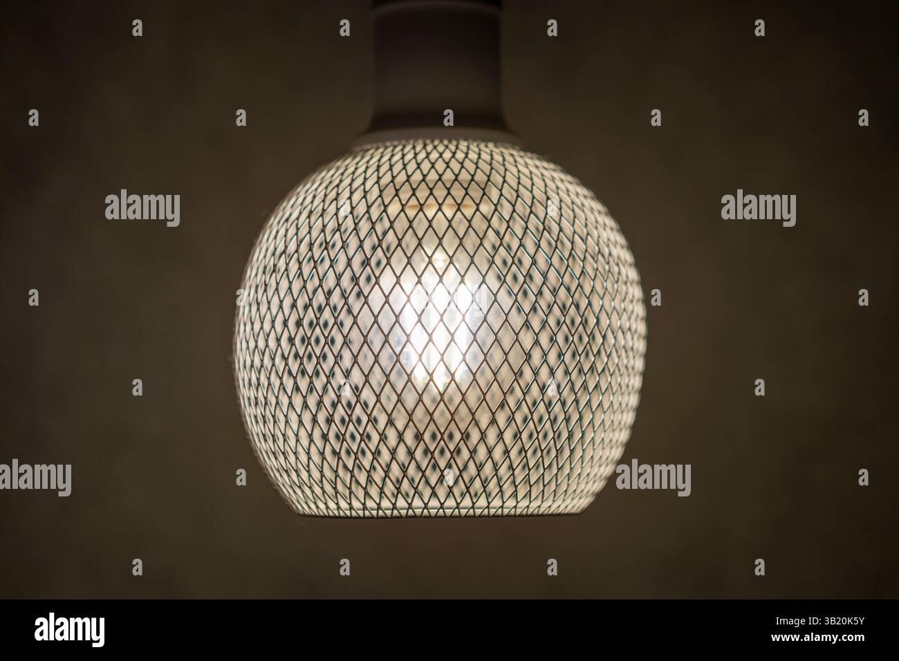 patterned light chandelier with light bulb on dark background Stock Photo