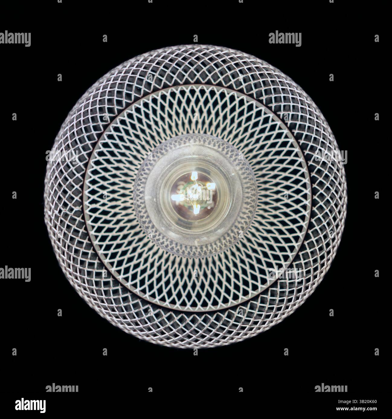 patterned light chandelier with light bulb on dark background Stock Photo