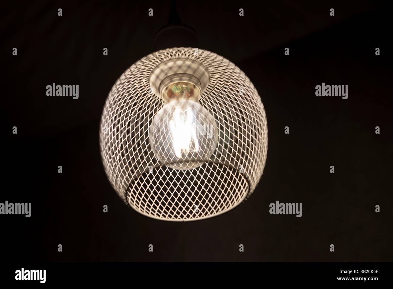 patterned light chandelier with light bulb on dark background Stock Photo