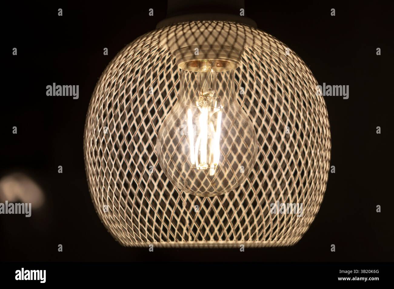 patterned light chandelier with light bulb on dark background Stock Photo
