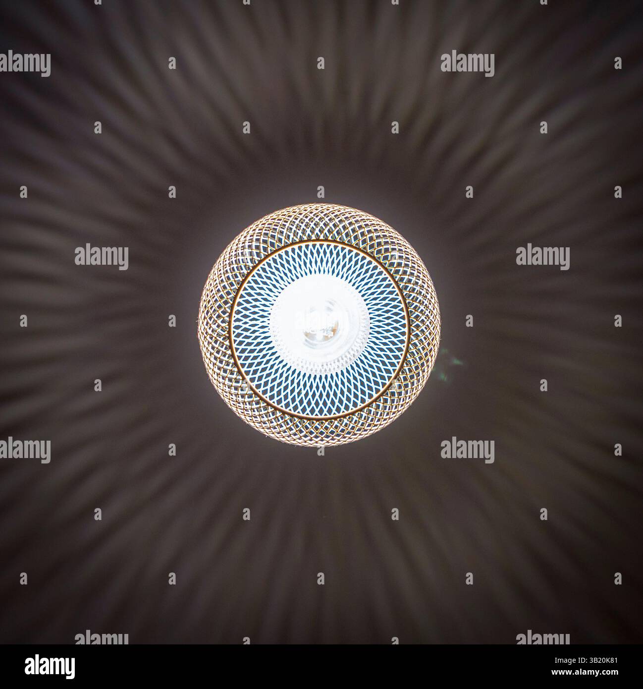 patterned light chandelier with light bulb on dark background Stock Photo
