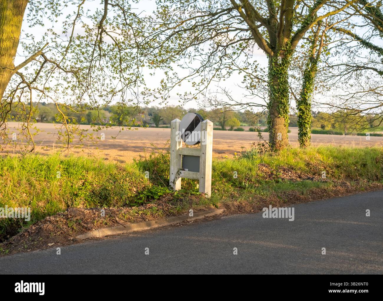 National speed limit sign marking the end of a rural road with a 30mph ...